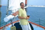 Tim Creehan enjoying a glass of wine on his boat